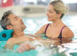 Man receiving occupational therapy in a pool.