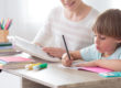 Woman working with a child at a desk.